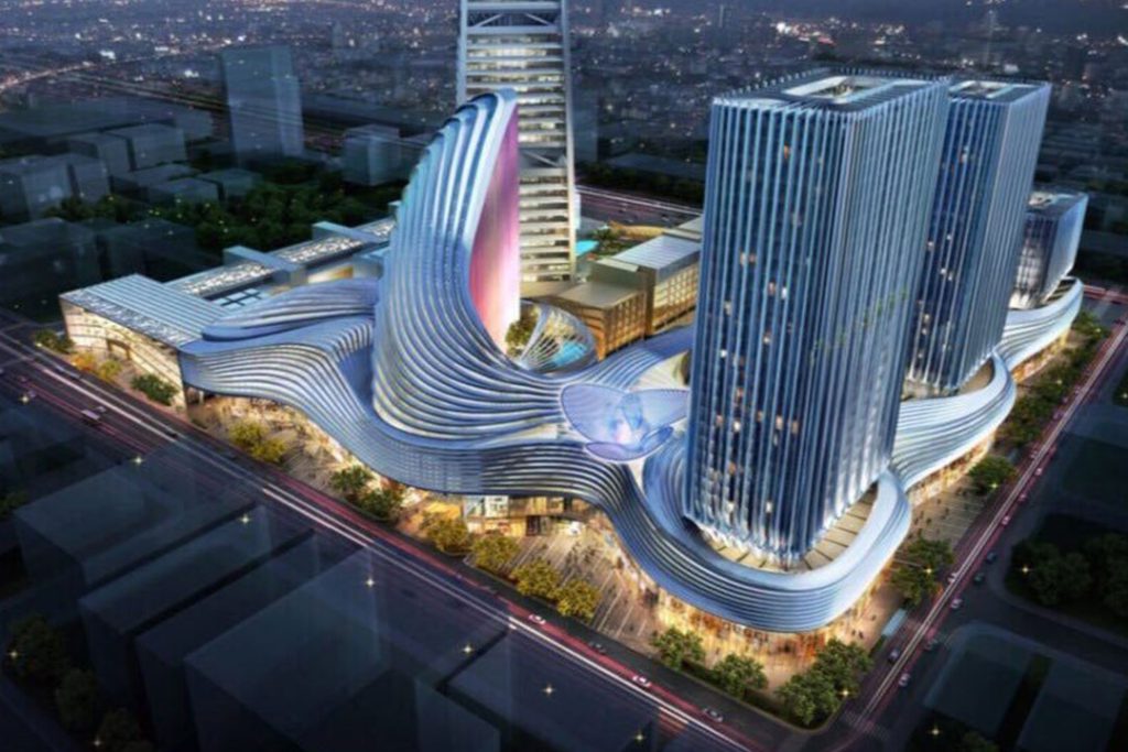 CGI aerial night view of a large mixed-use complex with sweeping curved roofs and glass towers