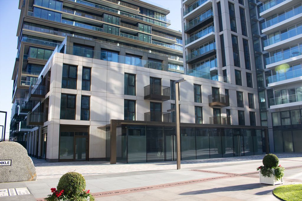 Cashmere Wharf: stone-clad apartment buildings with balconies above a paved public square