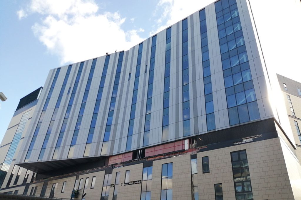 Royal Liverpool University Hospital facade with vertical windows and a cantilevered upper block